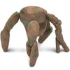 A brown soft plush toy resembling an alien creature with green markings.
