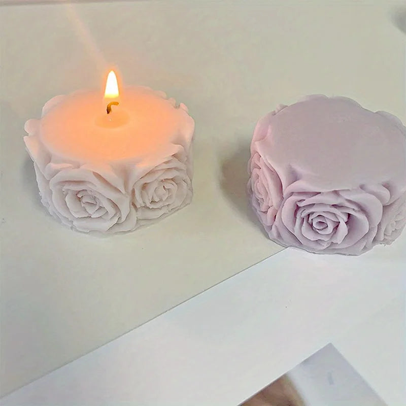 A pink silicone rose candle mold with a lit candle and a finished rose shape.