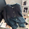 A dark teal faux fur cardigan sweater displayed on a hanger against a white background.