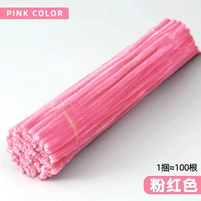 A pink color craft set of chenille stems shown in a close-up, elongated view.