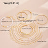 A set of 11 gold-toned bracelets featuring crystal hearts and infinity signs, displayed on a light background.
