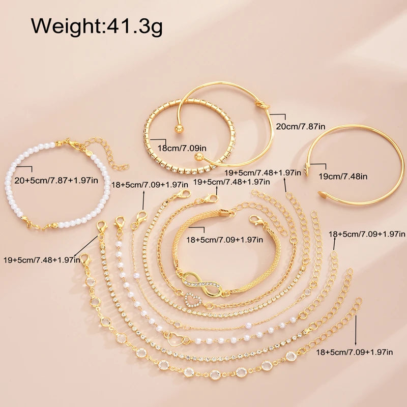 A set of 11 gold-toned bracelets featuring crystal hearts and infinity signs, displayed on a light background.