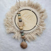 A personalized wooden baby pacifier clip featuring silicone beads and a natural fiber wreath.