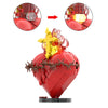 A red heart shaped building block set featuring a golden Sacred Heart of Jesus design.