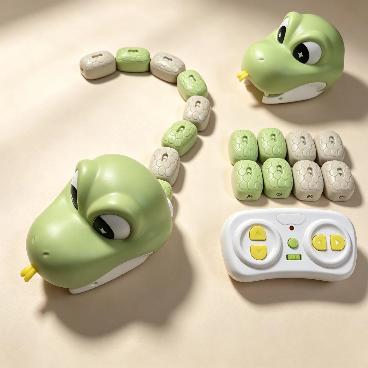 A green magnetic snake toy is shown coiled on a light background with several segmented pieces and a remote control.