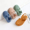 A collection of five girls' gladiator jelly sandals in various pastel colors including blue, pink, green, and orange.