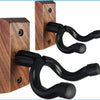 A dark wood wall mount hanger with a black curved hook for securing musical instruments.