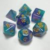 A set of seven polyhedral acrylic dice in shades of blue and purple scattered on a white surface.