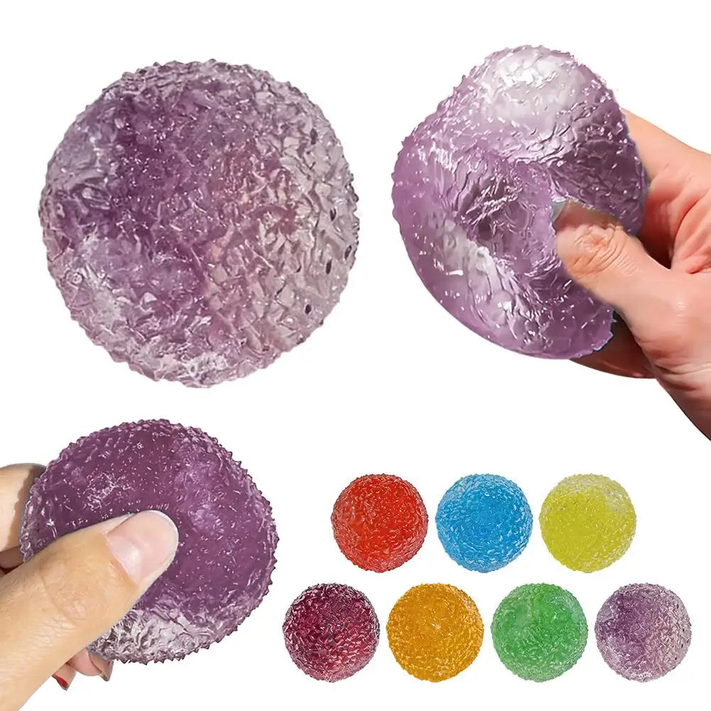 A collection of purple and translucent fidget balls, including a large sphere and several smaller, colorful balls, being held
