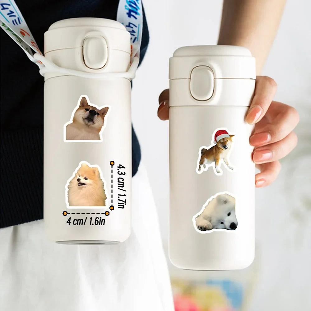 A white reusable water bottle with dog stickers featuring cartoon dogs, held by a person.