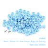 A pile of light blue round plates with a flower edge for building blocks