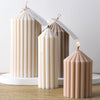 Three decorative silicone candles in cream and beige tones with thank you tags