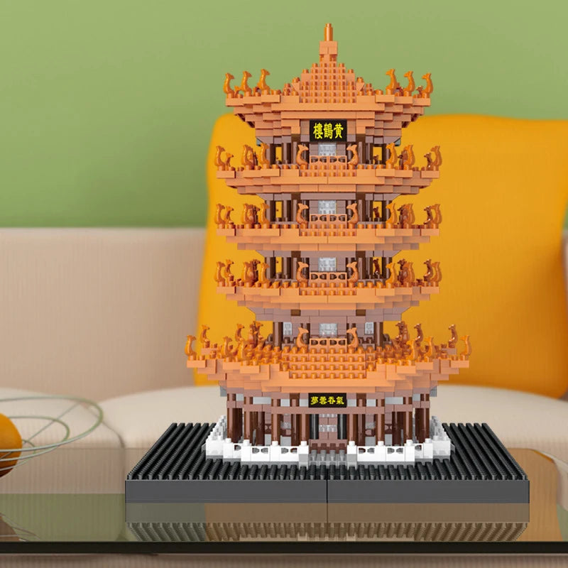 A detailed model of the Yellow Crane Tower built from orange and brown micro building blocks displayed on a dark base.