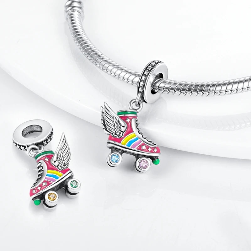 A silver heart charm bead featuring a pink zircon and an angel design attached to a sterling silver chain.