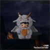 A plush doll pendant of a gray creature with horns and dark features, featuring an orange chest piece.