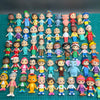 A collection of colorful PVC figurines depicting various cartoon characters and animals.