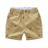 Khaki boys cotton beach shorts featuring a small anchor print and light blue lining.