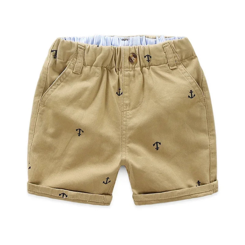 Khaki boys cotton beach shorts featuring a small anchor print and light blue lining.