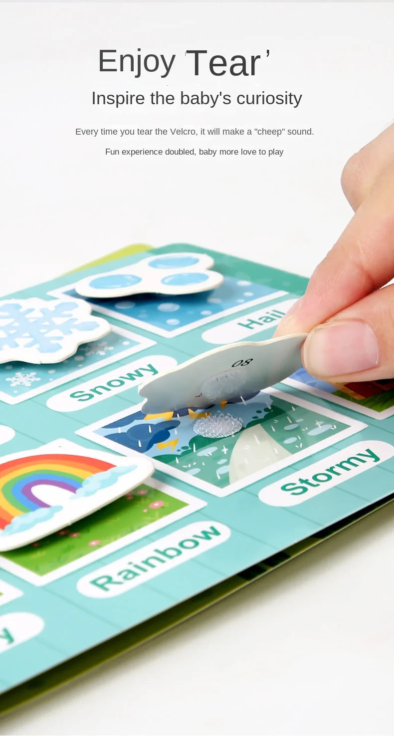 A hand is interacting with a Montessori quiet book featuring various weather themes like snowy, rainbow, and stormy stickers.