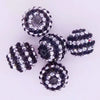 A cluster of ten mixed two-tone striped resin beads for jewelry making, approximately 20mm in size.
