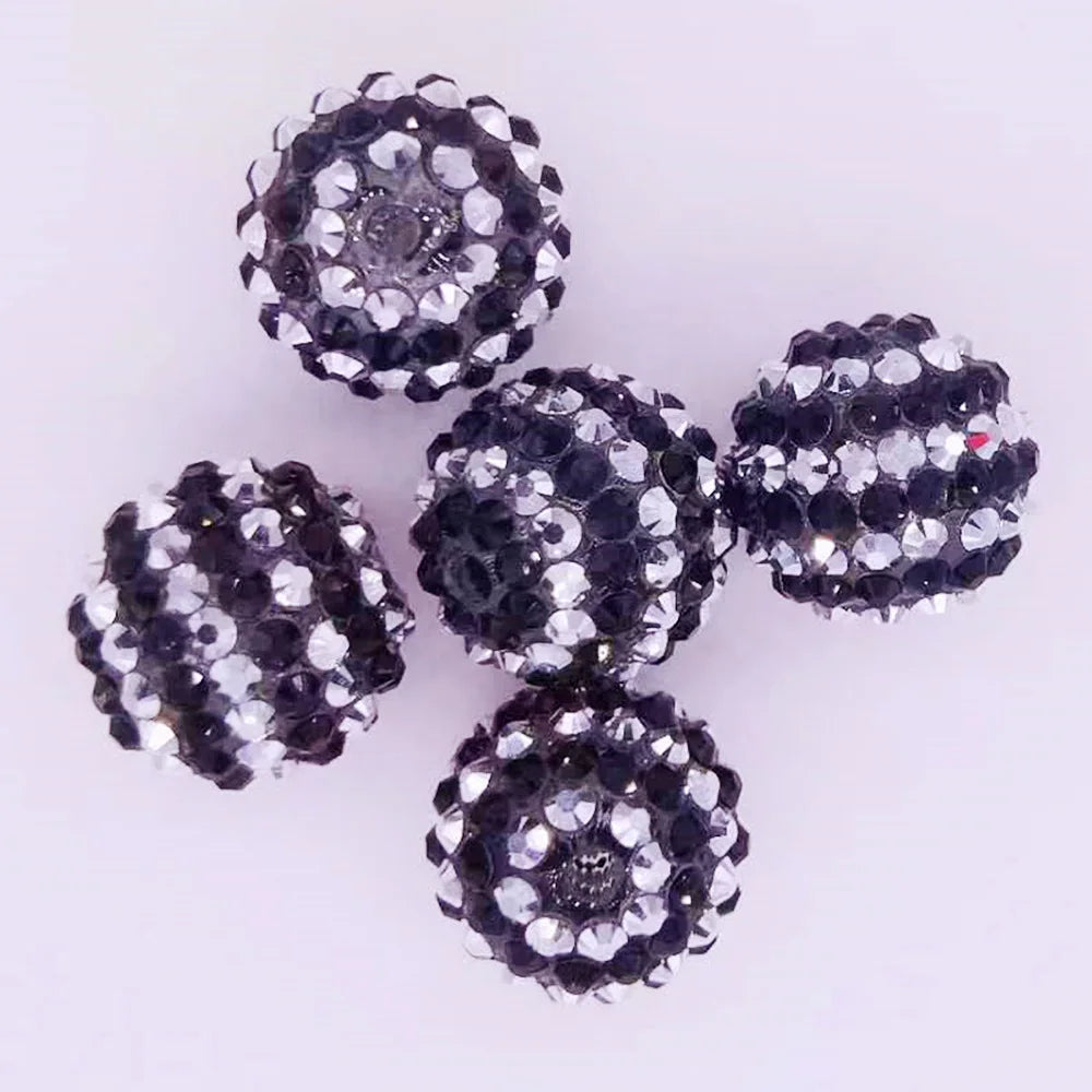 A cluster of ten mixed two-tone striped resin beads for jewelry making, approximately 20mm in size.