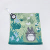 A soft green plush toy of a cat with gray fur and white accents, featuring a small tag.