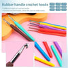 A collection of various sized and shaped rubber crochet hooks in different colors and materials displayed on a pink backgroun