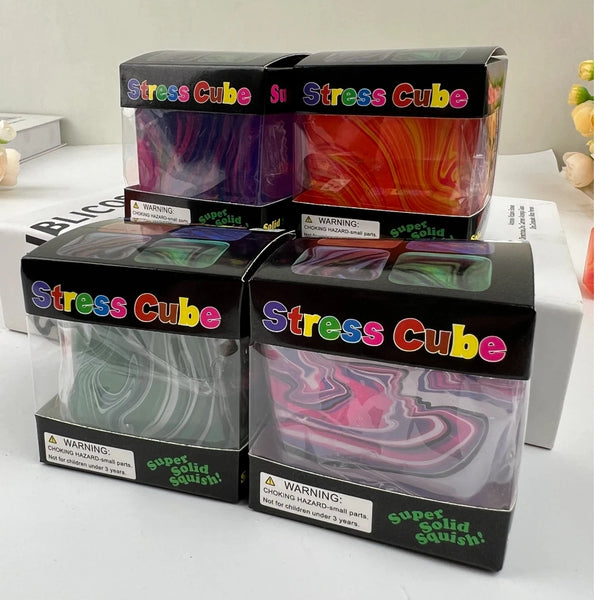 Three boxes of Stress Cube sensory toys in various colors and shapes displayed on a white surface.