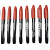 A pack of six black permanent fine-tip markers with orange and red caps arranged in a row.