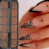 A close-up of gold caviar beads nail charms in mixed sizes being applied to a hand for DIY nail art.