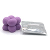 A pile of purple candle dye chips for soy wax, beeswax, and paraffin wax.