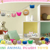 Assorted mini animal plush toys with keychain loops displayed in a white shelving unit.