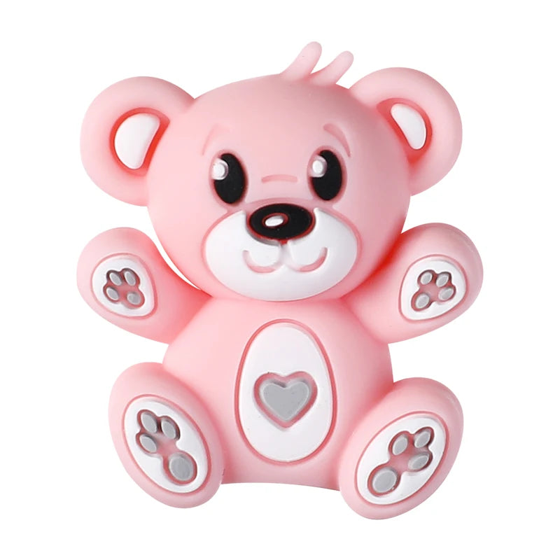 A pink silicone bear figurine with facial features and paw prints, used as a focal bead for DIY jewelry making.
