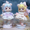 A pair of Mimia Art of Forgotten Dream Series collectible figurines featuring light blue and yellow hair with pink accents.