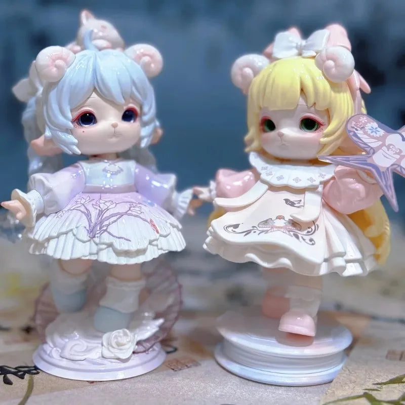 A pair of Mimia Art of Forgotten Dream Series collectible figurines featuring light blue and yellow hair with pink accents.