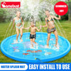 Three children playing with a blue inflatable water splash mat outdoors in a grassy area.