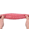 A hand is squeezing a pink, brain-shaped stress relief ball for anxiety and focus.