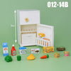 A white dollhouse playset featuring kitchen and living room furniture, including food items like fruit and bread.