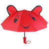 A red umbrella shaped like a bear face with black eyes and a smiling mouth.