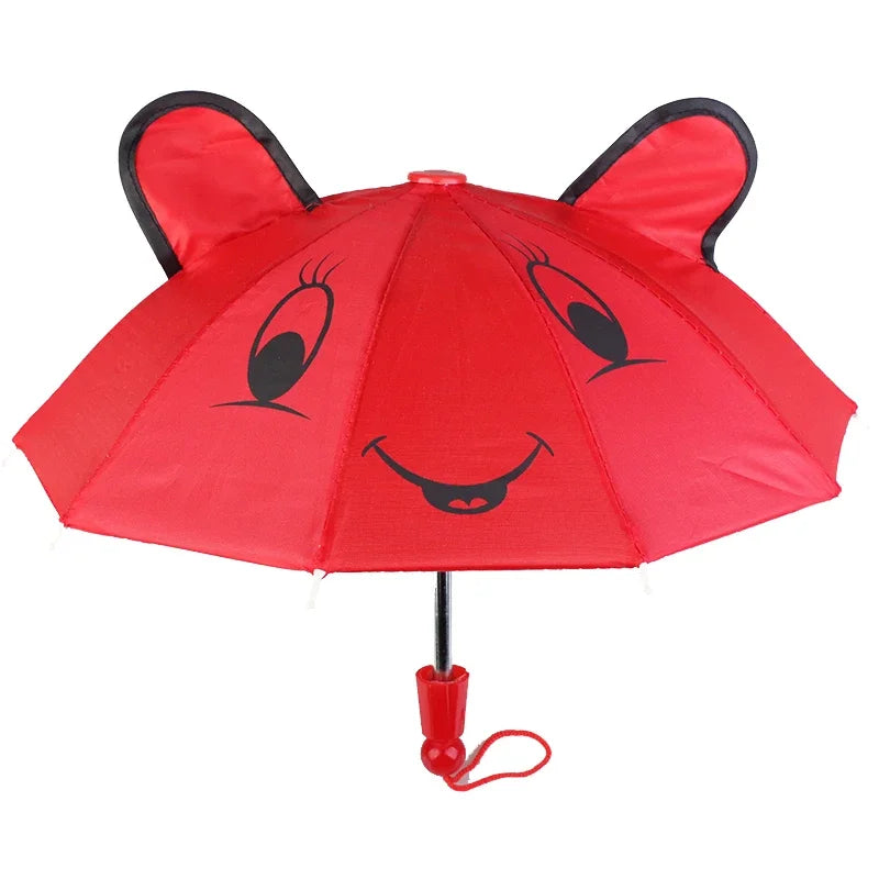 A red umbrella shaped like a bear face with black eyes and a smiling mouth.