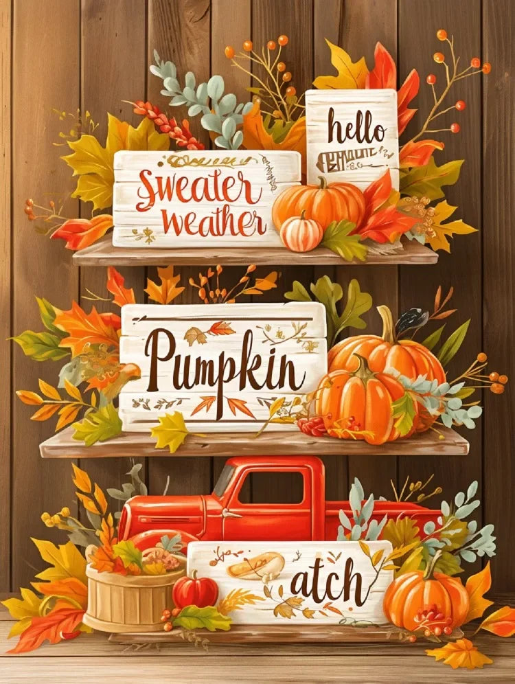 A display of wooden signs and pumpkins used as decorative elements for an autumn themed diamond painting kit.