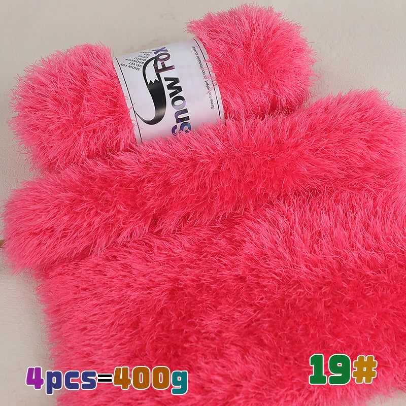 A bright pink chunky faux fur yarn product with a label showing the brand Snow Fox and a weight of 400g.