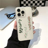 A white smartphone decorated with a green and pink floral lace pattern featuring roses and morning glory vines.
