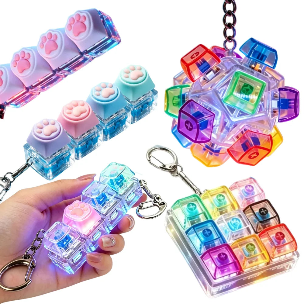 A collection of clear acrylic LED light-up keycaps and fidget items displayed on a hand.