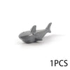 A gray plastic model of a shark or marine creature used as an ocean animal building block.