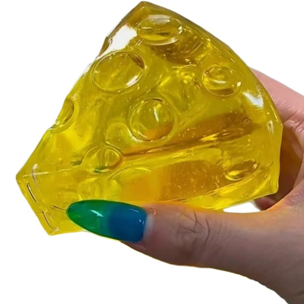 A hand holds a yellow, translucent honey cheese squishy stress ball with bubble features.