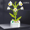 A set of 133 plastic rose flower building blocks in white and yellow, arranged on a white base.
