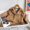 A tan faux leather zip-up jacket displayed on a white box, with sunglasses resting on the garment.