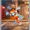 A Tracer collectible figurine in orange and white armor is shown mid-action with glowing blue energy effects.