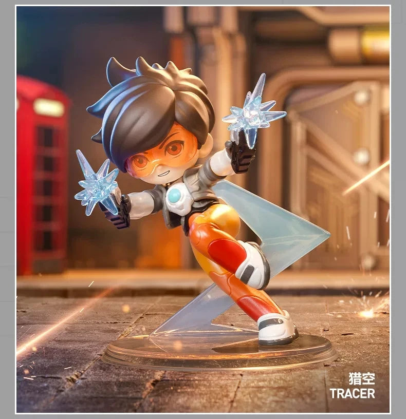 A Tracer collectible figurine in orange and white armor is shown mid-action with glowing blue energy effects.